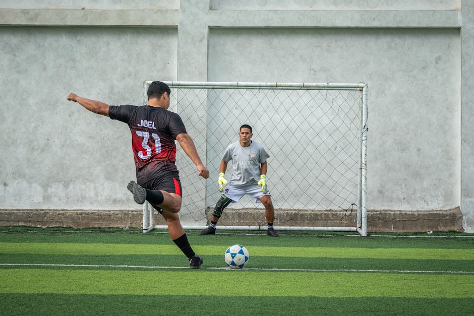 soccer penalty shootout moment with goalkeeper diving