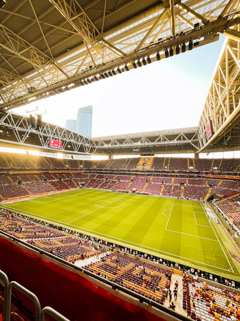 modern football stadium filled with colorful fans waving flags