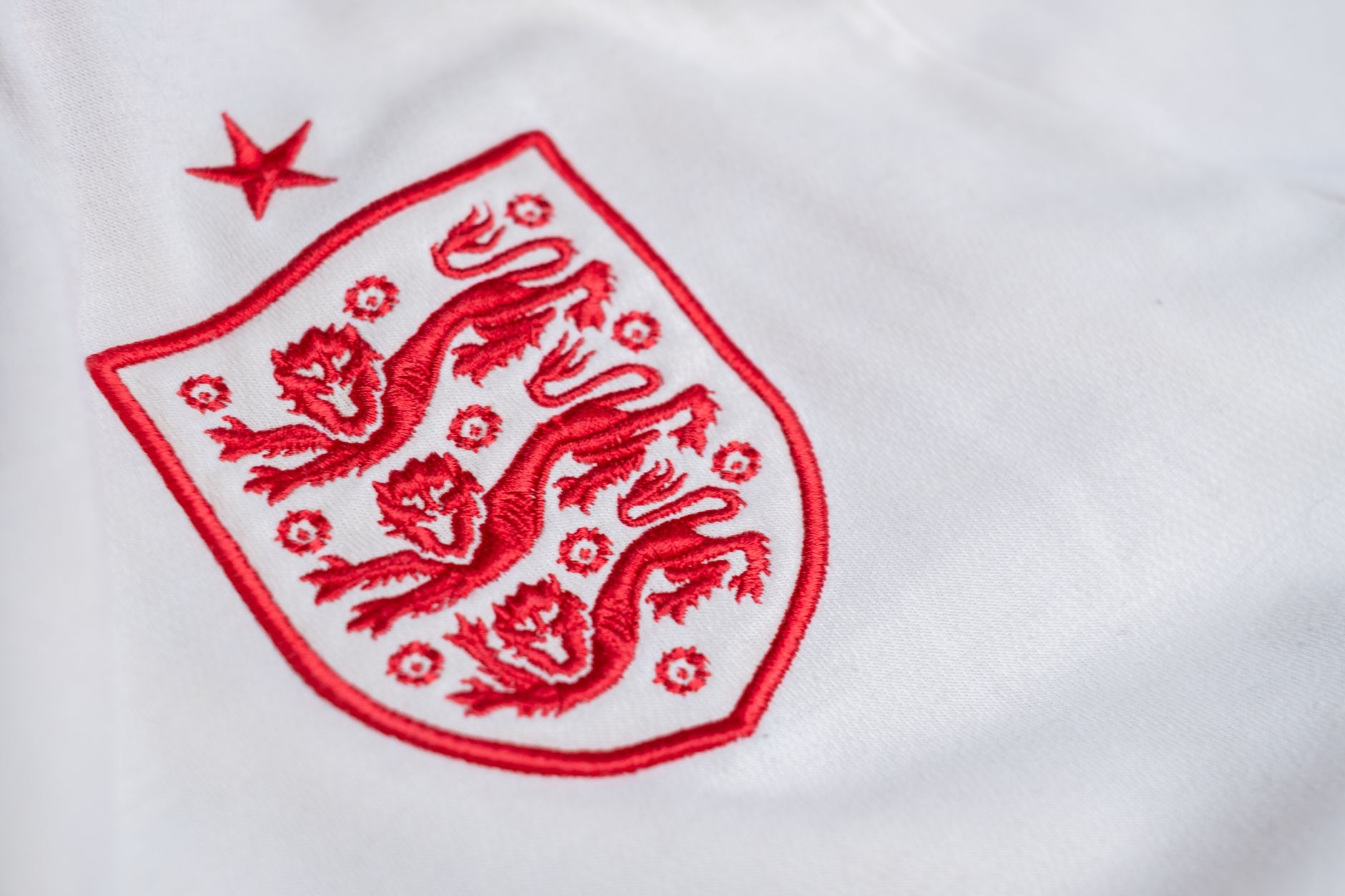 Detailed look at the England national football team's emblem on a jersey.